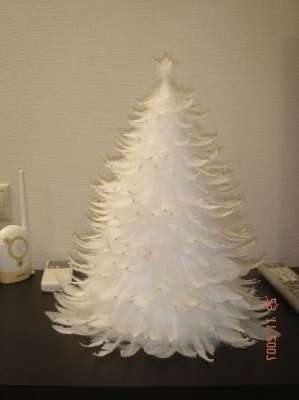 Kun pohja on valmis, liimaa siihen höyhenneulat. Aloita höyhenen liimaaminen alhaalta ympyrässä aivan ylhäältä. Höyhenet on liimattu varteen luomaan tilavuutta pörröiselle osalle.