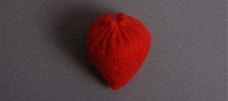 4. Vezmite ihlu s červenou niťou a stehom na stehovanie, prišite horný okraj jahody