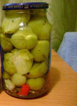 اغسل الطماطم الخضراء وحضر الأعشاب والثوم والفلفل. ضعي جميع المكونات في زجاجة سعة ثلاثة لترات ، بما في ذلك الطماطم الخضراء.